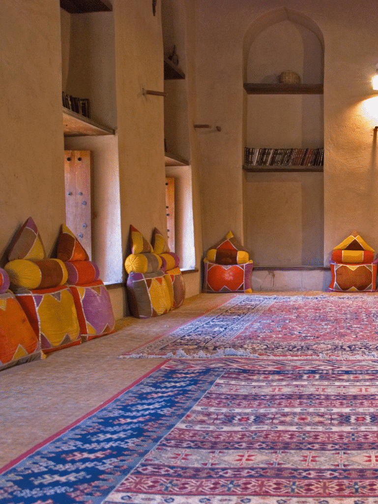 Traditional Arabic Majlis interior with colorful cushions and patterned rugs on the floor