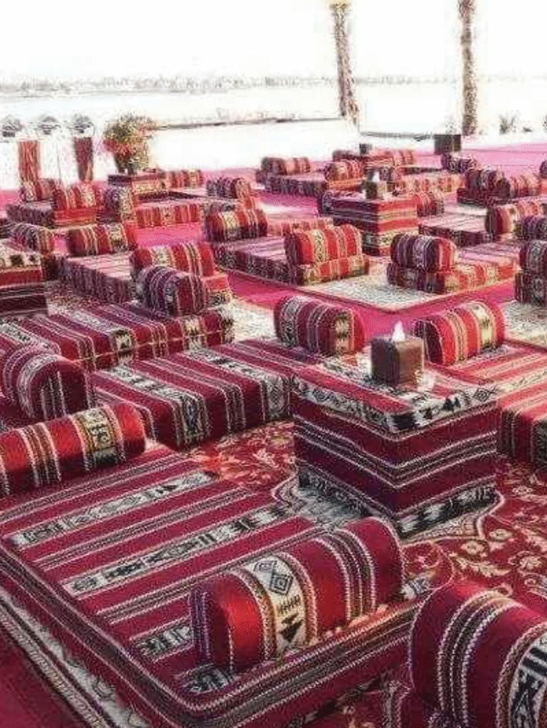 Traditional Arabic Majlis interior with colorful cushions and patterned rugs on the floor