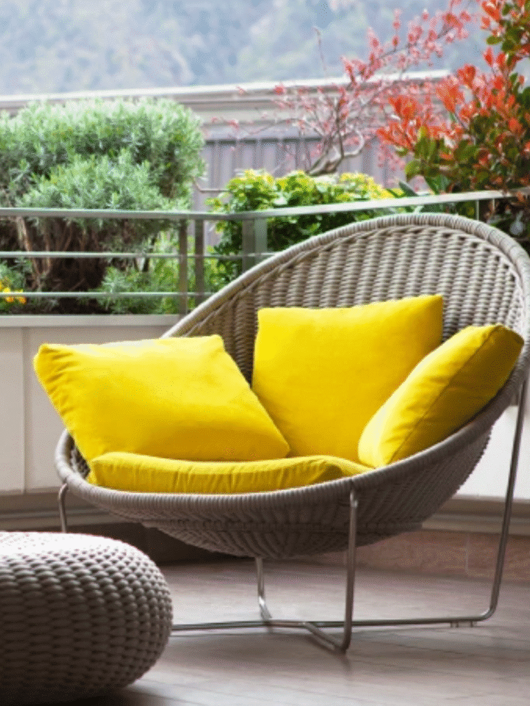 Outdoor patio chair with yellow cushion and modern design.