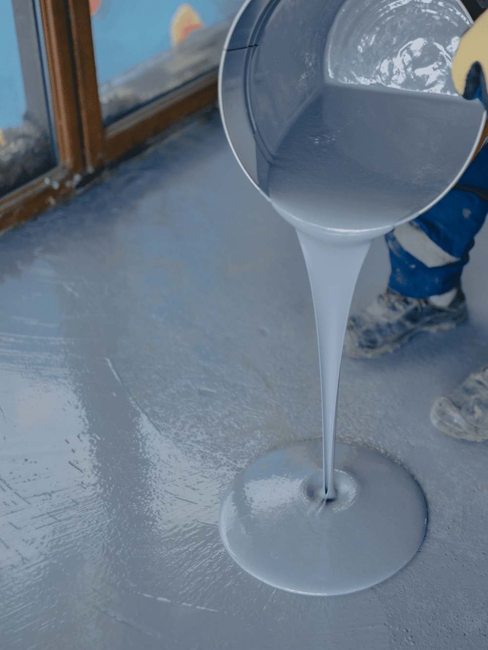 Pouring liquid epoxy flooring during installation