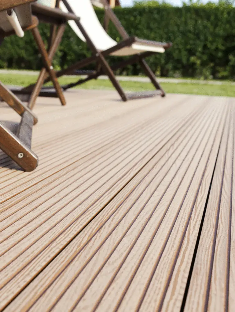 Close-up of wooden deck flooring with outdoor chairs